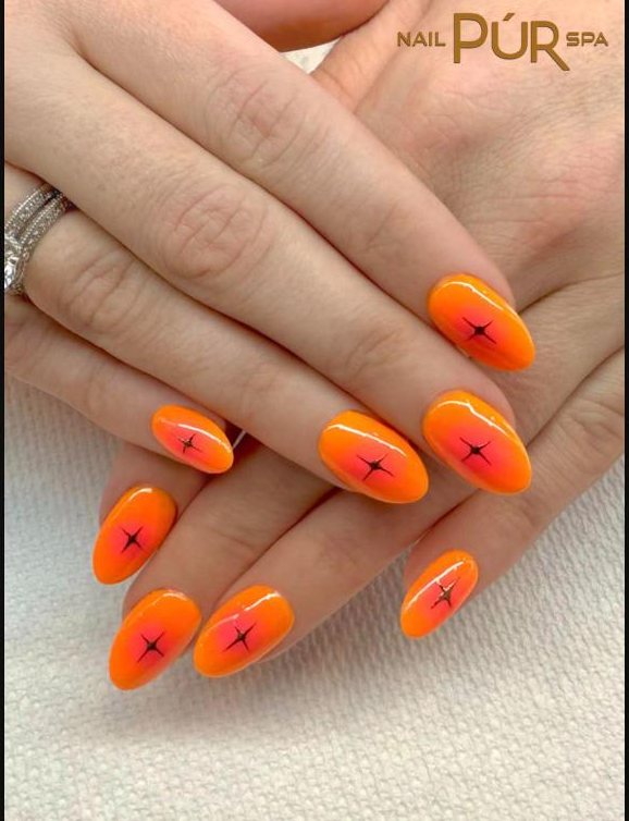 Orange ombré almond nails with black star details
