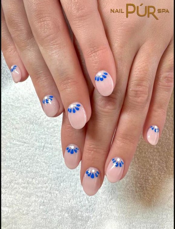 Short natural nails with blue petal accents